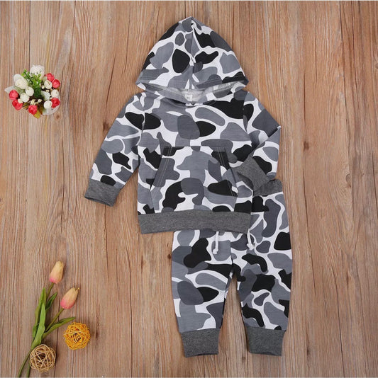 Boys camo hoodie and jogger suit with stylish black,grey, and white camouflage print, featuring a front kangaroo pocket. perfect for active kids who love adventure and outdoor play, this trendy outfit offers durability and flexibility for everyday wear.