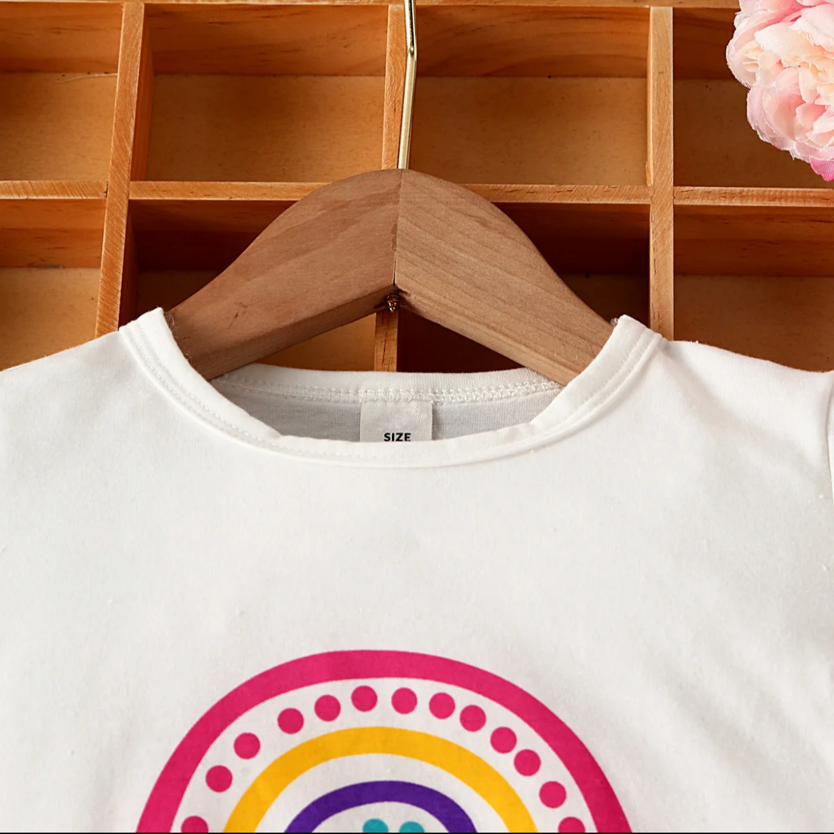 Girls short sleeve t-shirt with rainbow design on the front, made from soft cotton, polyester, and elastane for a comfortable fit.
