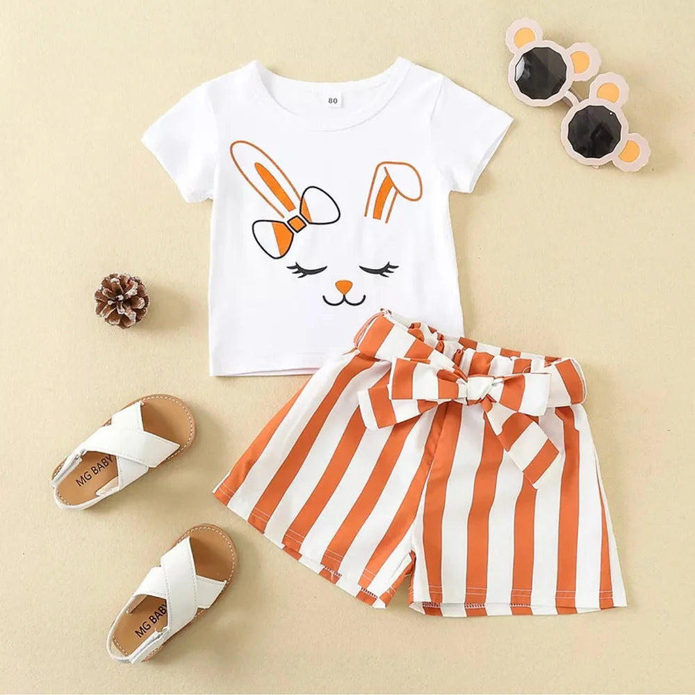 “Girls’ bunny face t-shirt and striped belted shorts set – front view. Adorable bunny print on a soft cotton t-shirt, paired with stylish striped shorts, perfect for casual playdates and outings. Comfortable, breathable, and ideal for active girls.”