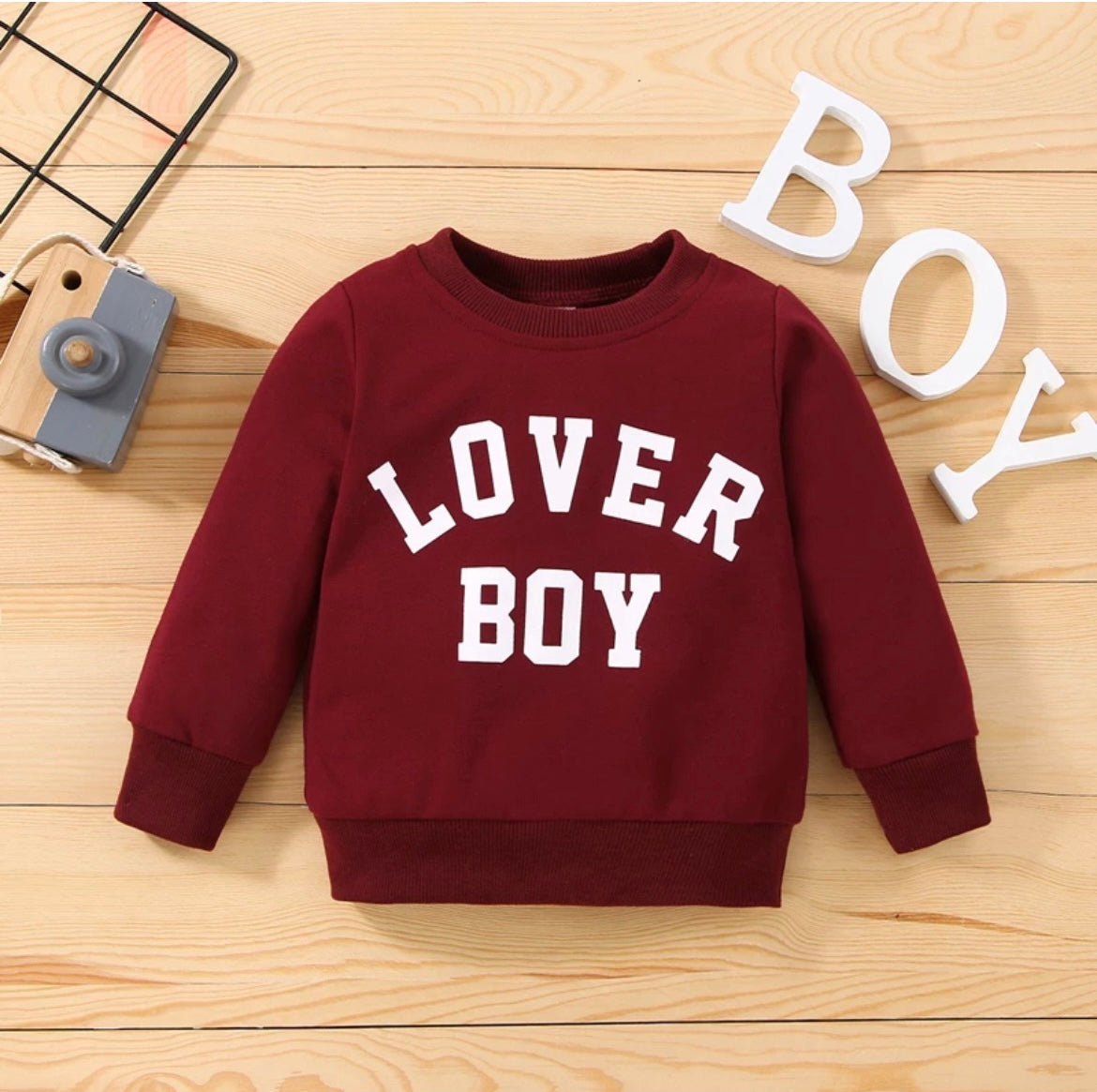 “Front view of the Kids’ Boy Crew Neck Sweater featuring ‘Lover Boy’ in bold letters across the chest. Made from soft, high-quality fabric, this stylish sweater offers warmth and comfort for boys, perfect for casual outings or playdates.”