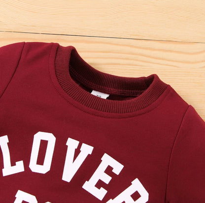 “Front view of the Kids’ Boy Crew Neck Sweater featuring ‘Lover Boy’ in bold letters across the chest. Made from soft, high-quality fabric, this stylish sweater offers warmth and comfort for boys, perfect for casual outings or playdates.”