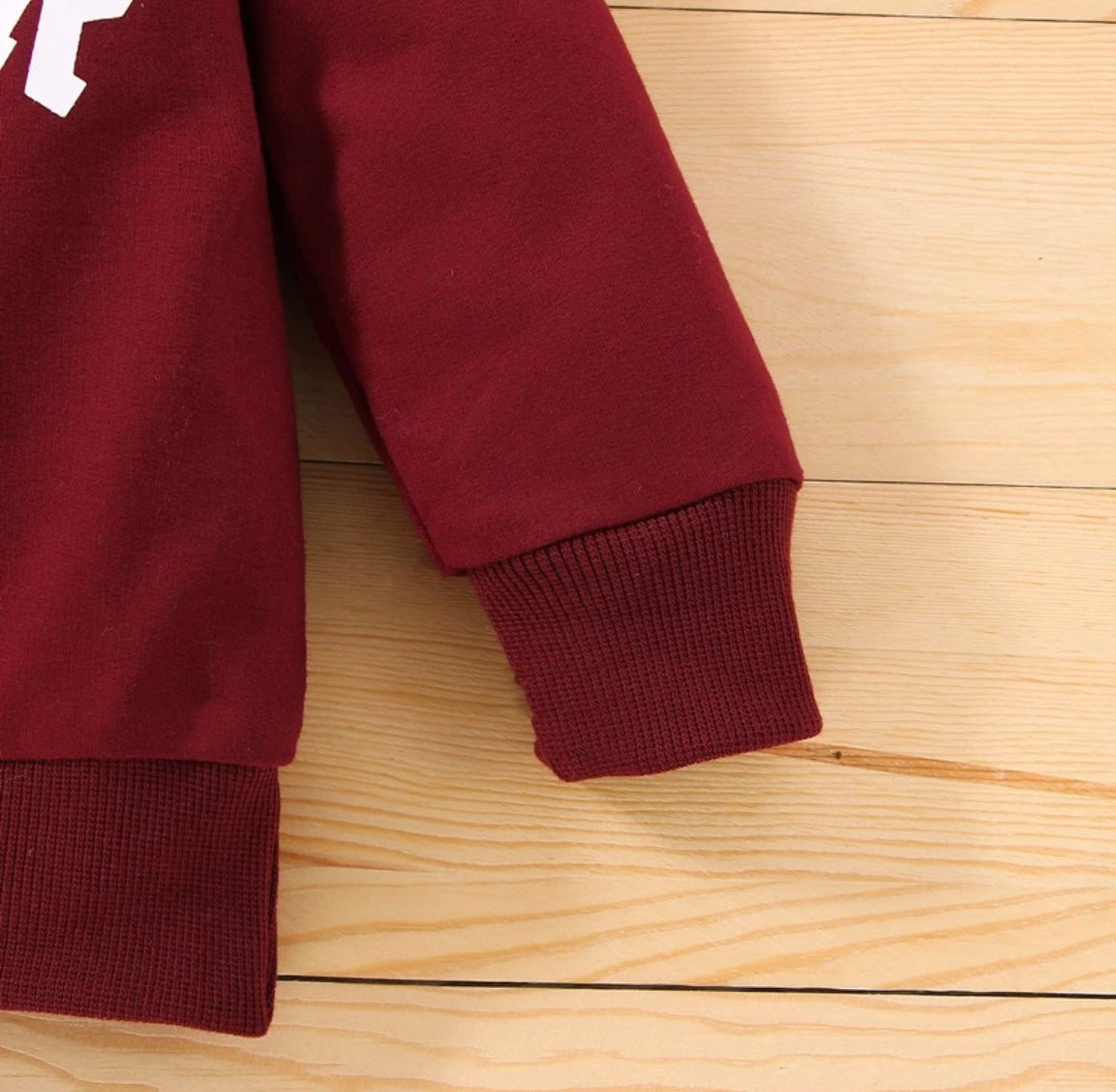 “Close-up of the detailed sleeve on the Kids’ Boy Crew Neck Sweater, showcasing the durable stitching and high-quality material that ensures long-lasting wear and comfort for active boys.”